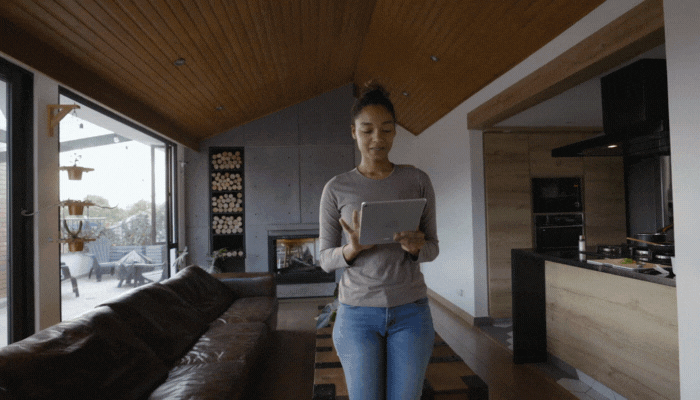 Woman using smart control to turn on lights