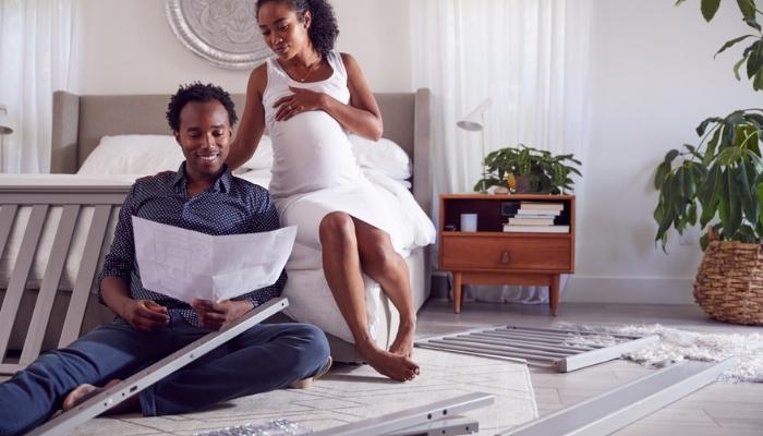couple looking at instructions for crib