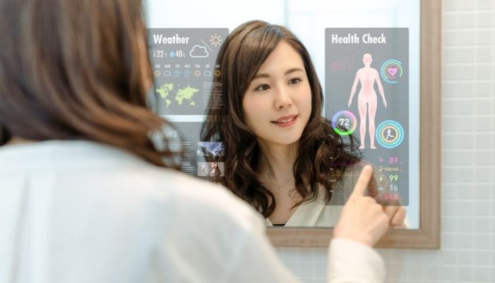 Woman using smart mirror to start her day