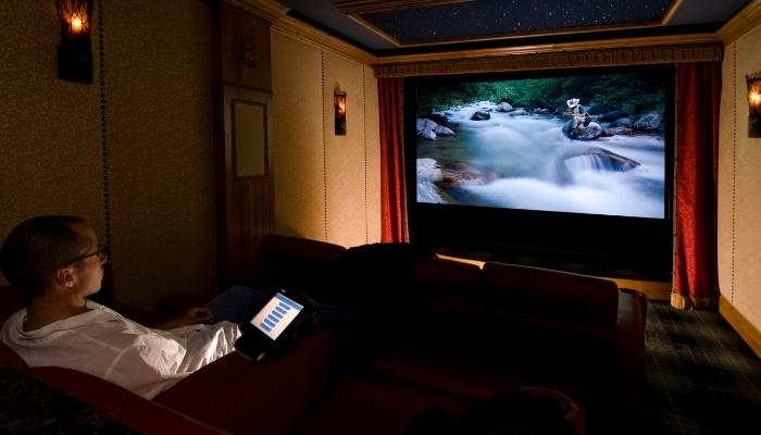 Man watching program in home theater