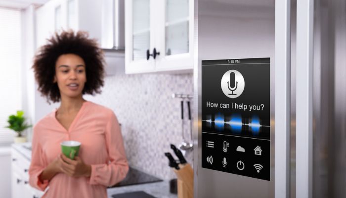woman looking at refrigerator with voice recognition function