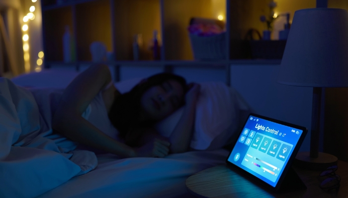 Woman sleeping while her smart system has all the lights off