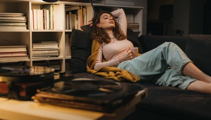 woman listening to records on couch
