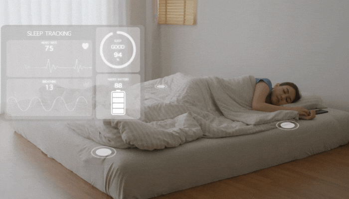 Woman using sleep tracking technology to monitor her health as she sleeps