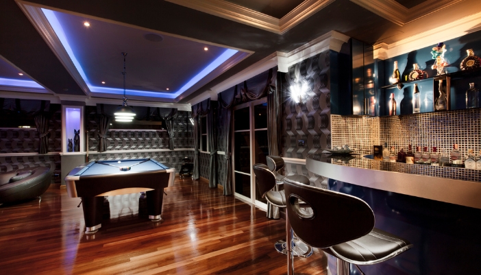 Luxury game room with pool table and home bar