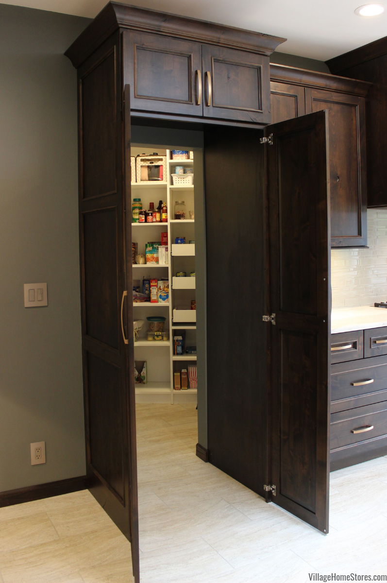 Hidden pantry cabinet front with doors open to show walk in pantry behind. 