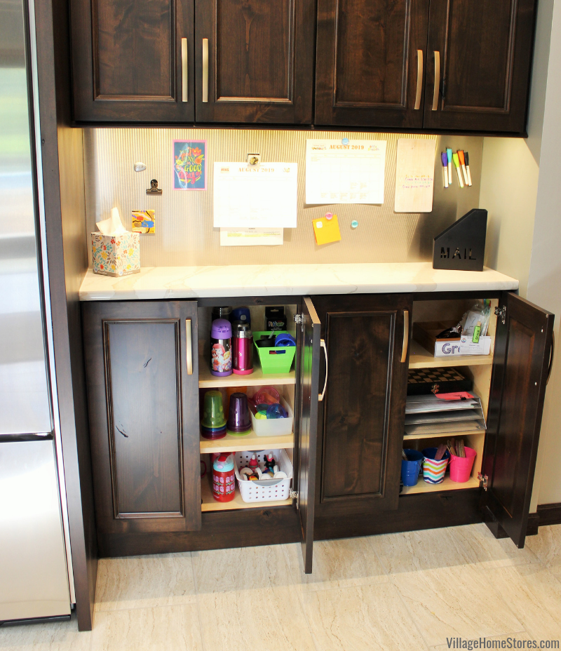 Kids containers, cups, and supplies shown in open cabinets with magnetic panel on wall above for command center.