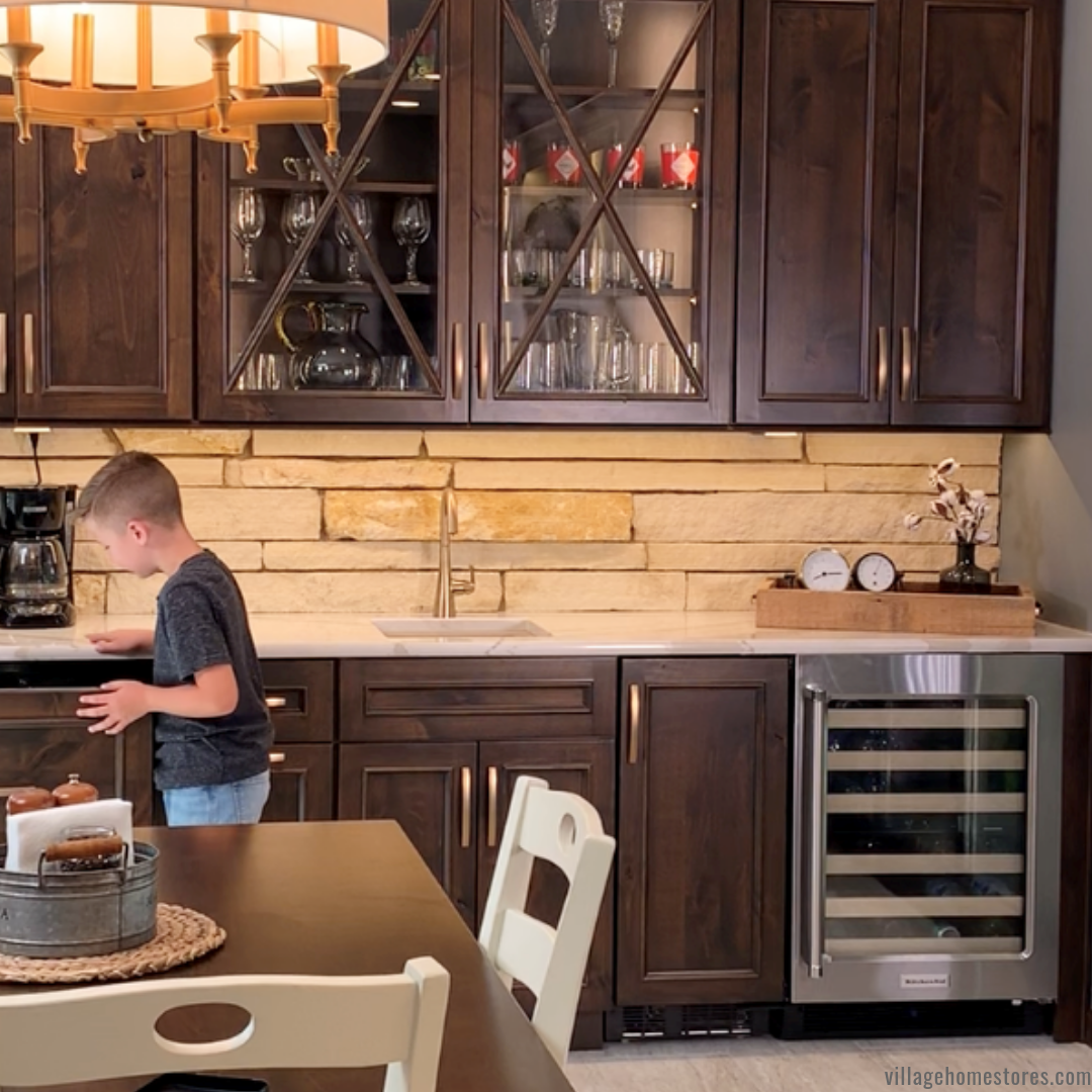 boy at panel-front refrigerated drawer in a wet bar area if kitchen design