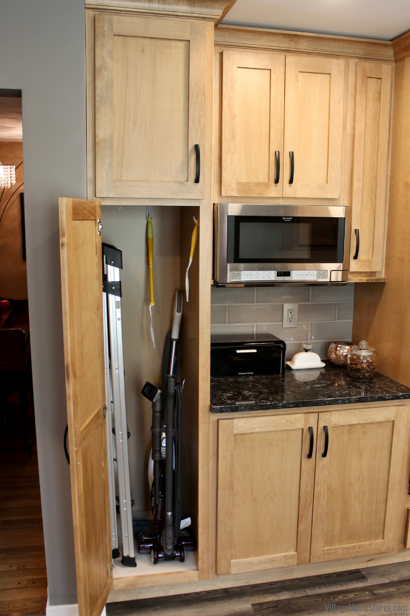 Tall pantry cabinet used as kitchen broom closet and cleaning supply closet