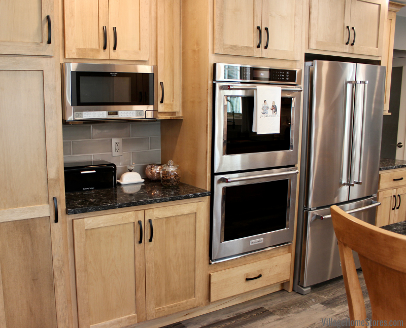 Maple Pecan stained kitchen with stainless steel wall ovens and over the counter microwave installed