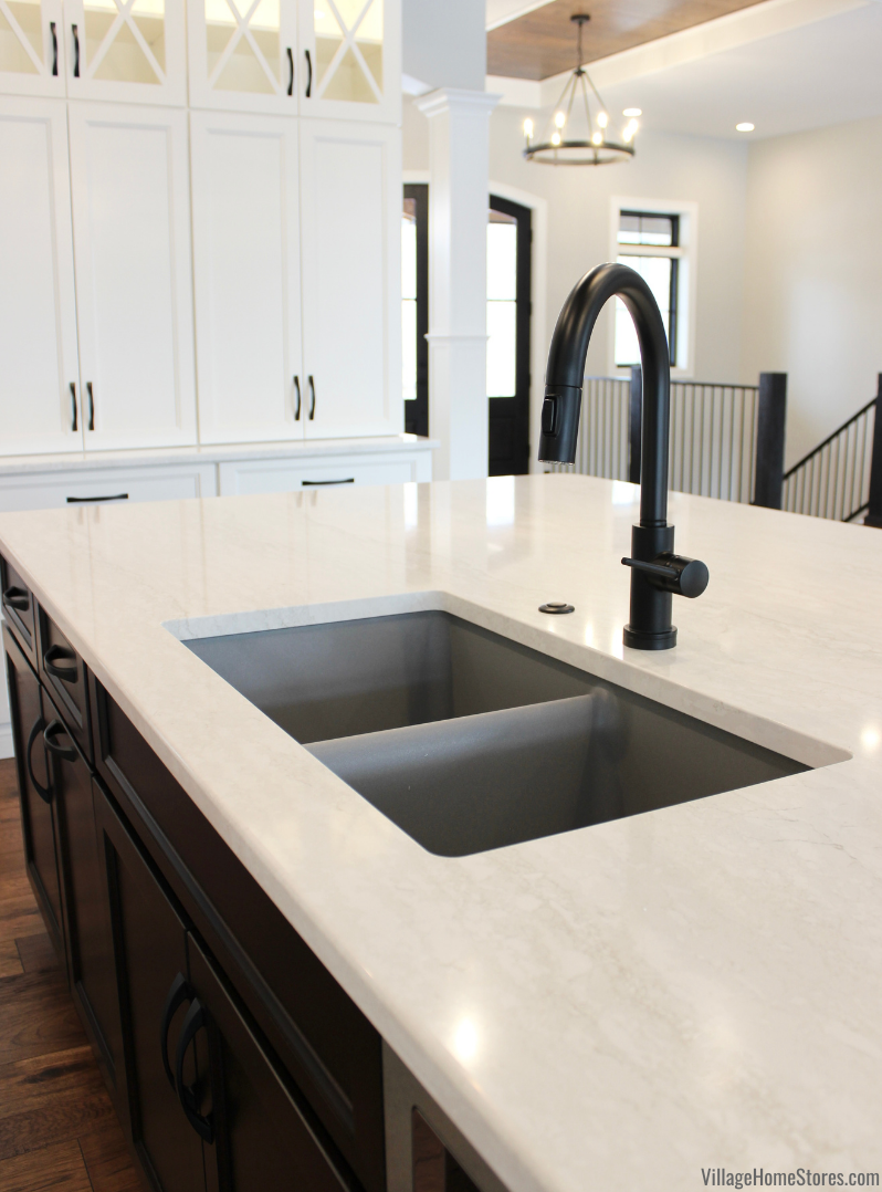 Cambria Quartz Ironsbridge countertops installed with a gray undermount sink and matte black faucet and disposal button. 