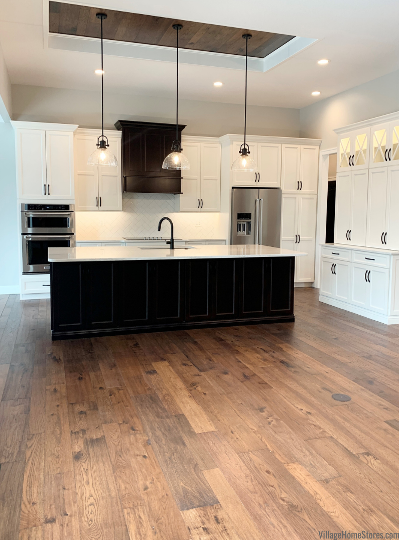 Hallmark wood flooring on floors and tray ceiling of a great room kitchen. Hallmark flooring by Village Home Stores for Hazelwood Homes of the Quad Cities.