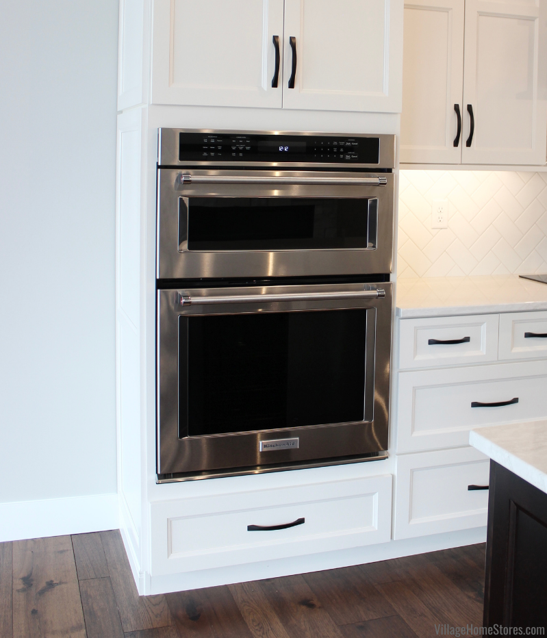Combination microwave and wall oven by KitchenAid installed in a Coal Valley Illinois kitchen with white cabinets from Village Home Stores for Hazelwood Homes.