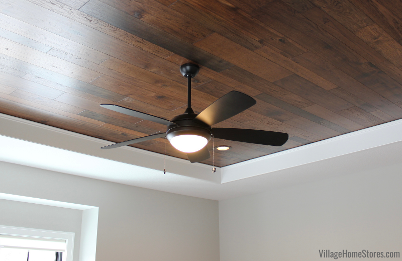 Wood ceiling in bedroom with LED fan. Flooring and ceiling fan by Village Home Stores for Hazelwood Homes of the Quad Cities.