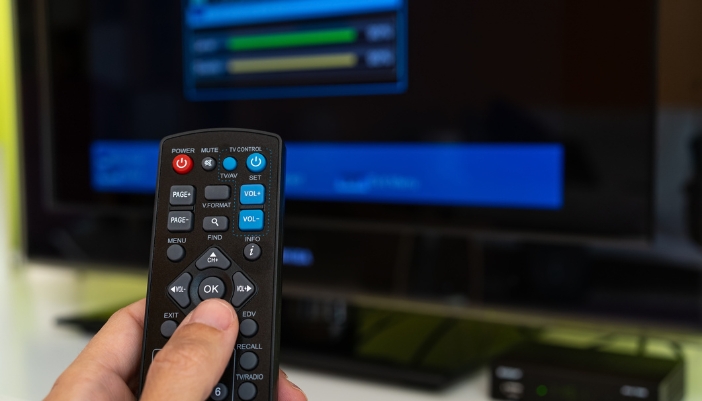 Closeup of remote as someone changes the settings on their TV