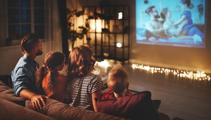 Family watching movie on a projector screen