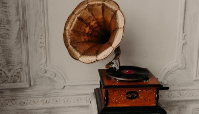 Vintage phonograph in front of white wall