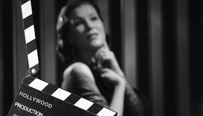 Black and white photo of actress and clapboard