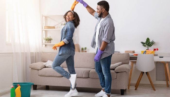 couple dancing while cleaning