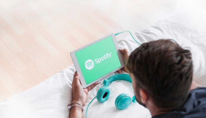 Man streaming Spotify on his tablet
