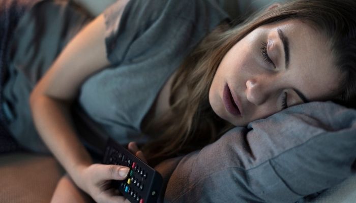 woman sleeping while watching tv