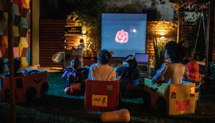 Kids in cardboard "cars" at an outdoor movie