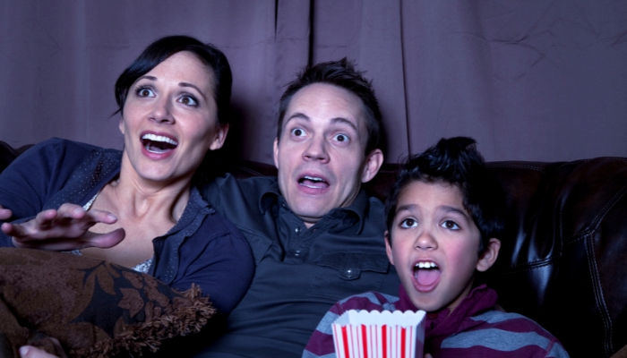 Family fully immersed while watching a scary/thrilling movie