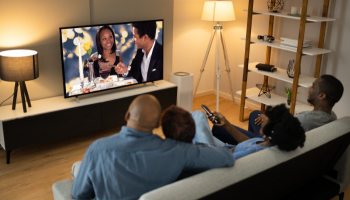 Family watching a decent-sized TV for their living room