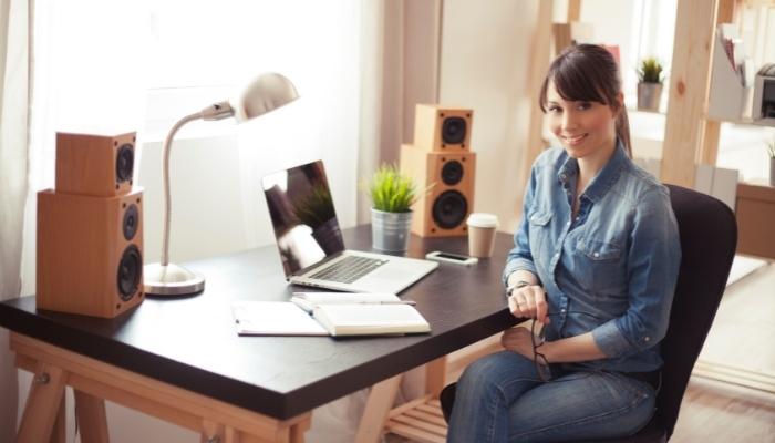 woman in home office featuring bookshelf speakers