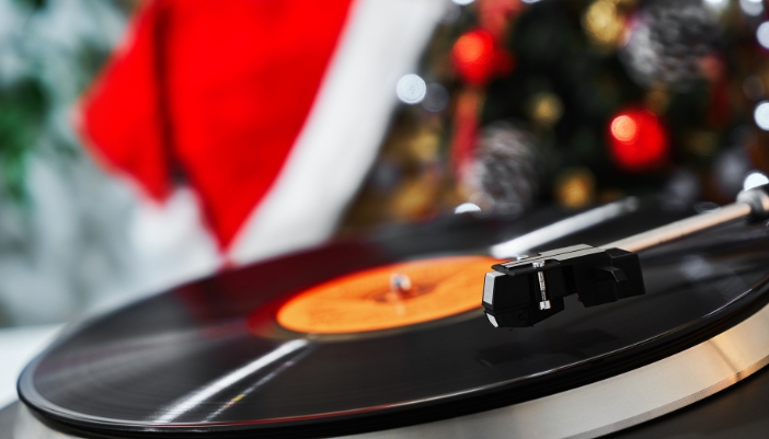 Closeup of vinyl player in front of the holiday decorations