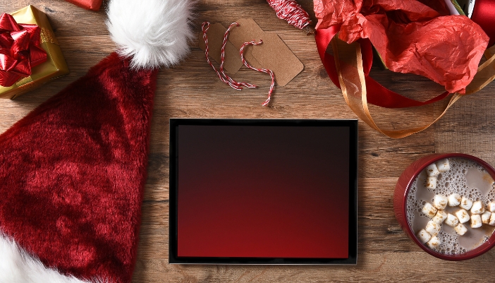 Tablet just opened as a present, surrounded by holiday-themed decorations
