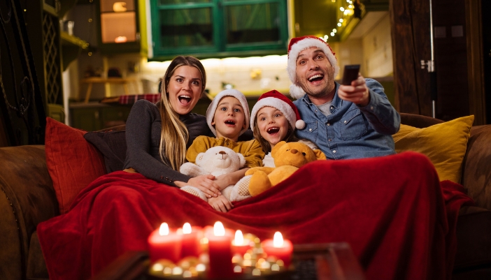 Couple with two kids having a movie night in for the holidays