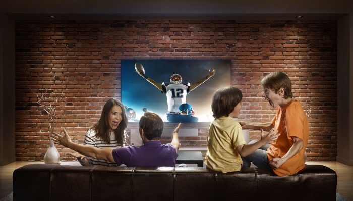 Family watching football on a really clear screen