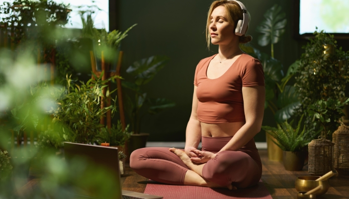 Woman listening to music while trying to meditate