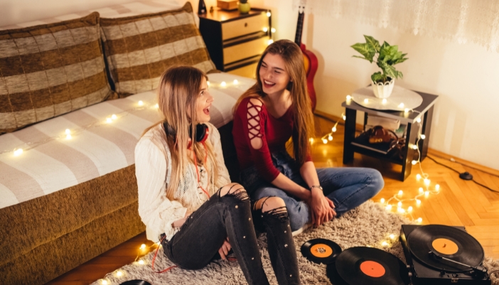 Two teens having fund with their record player