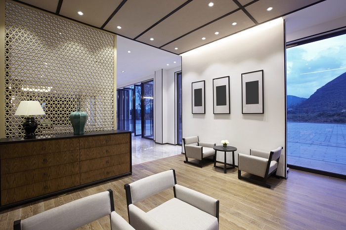 Modern open floorplan living room with overhead lights in a luxury home. 