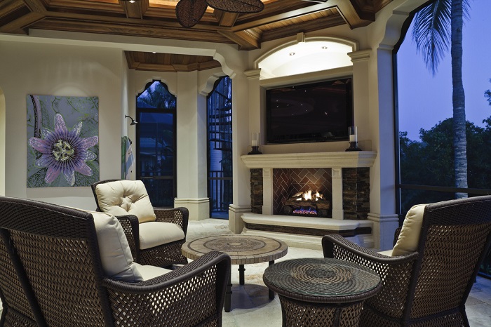 Outdoor covered patio with a flat screen tv, fireplace, and furniture