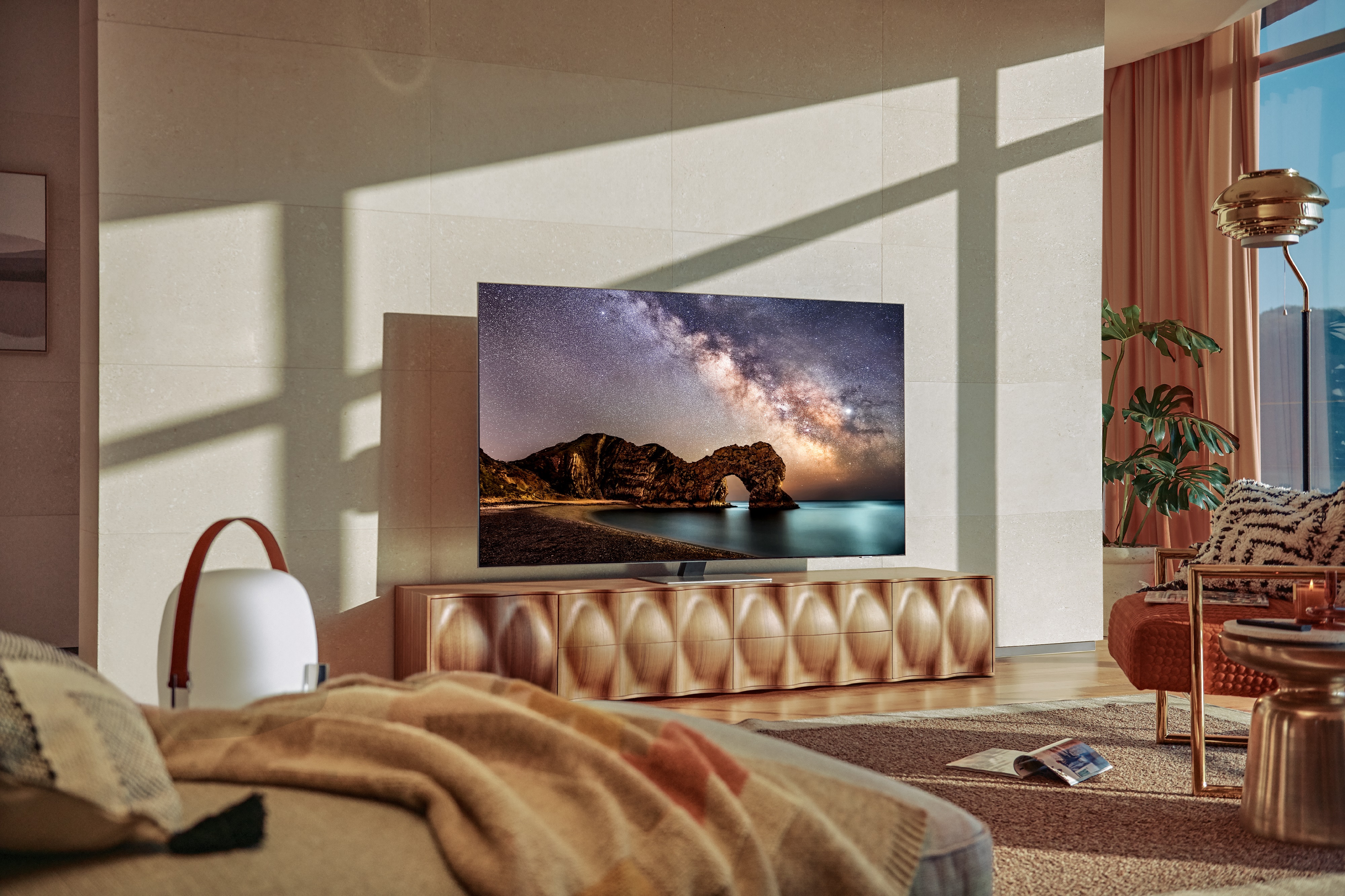 lone Samsung QN85A TV on stand in sunlit living room