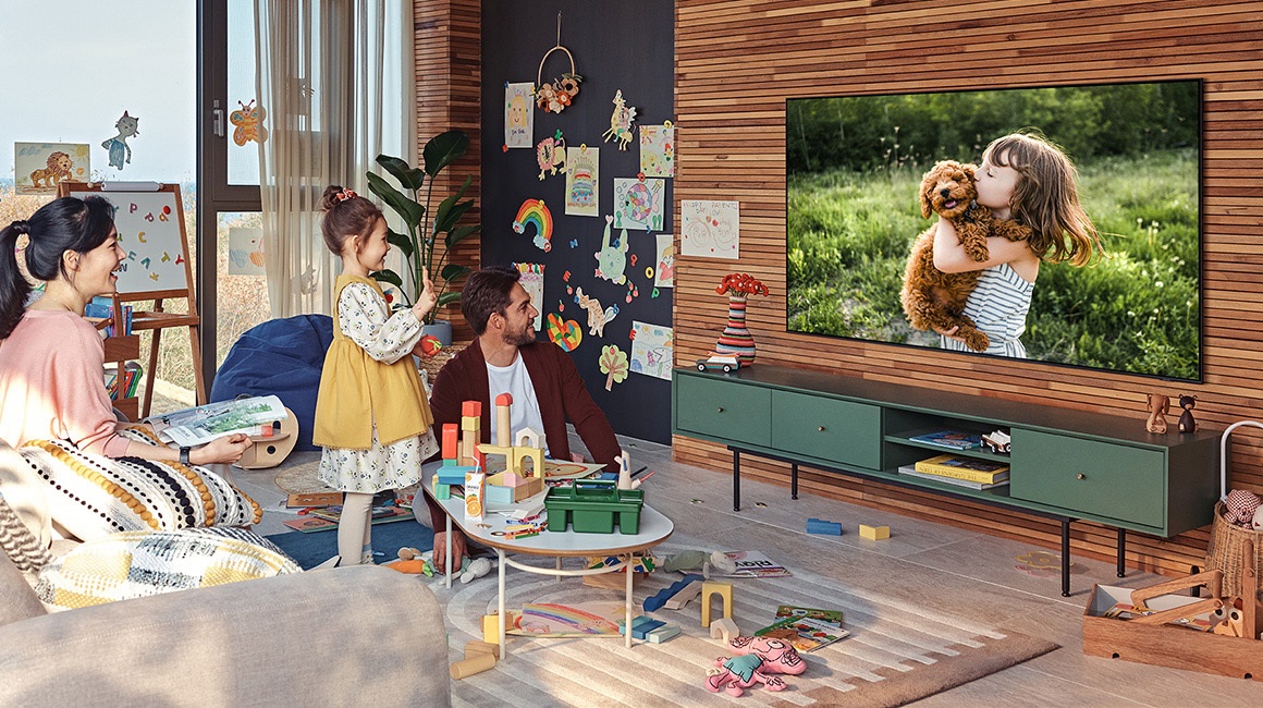 family watches content on Samsung Q60A TV in playroom