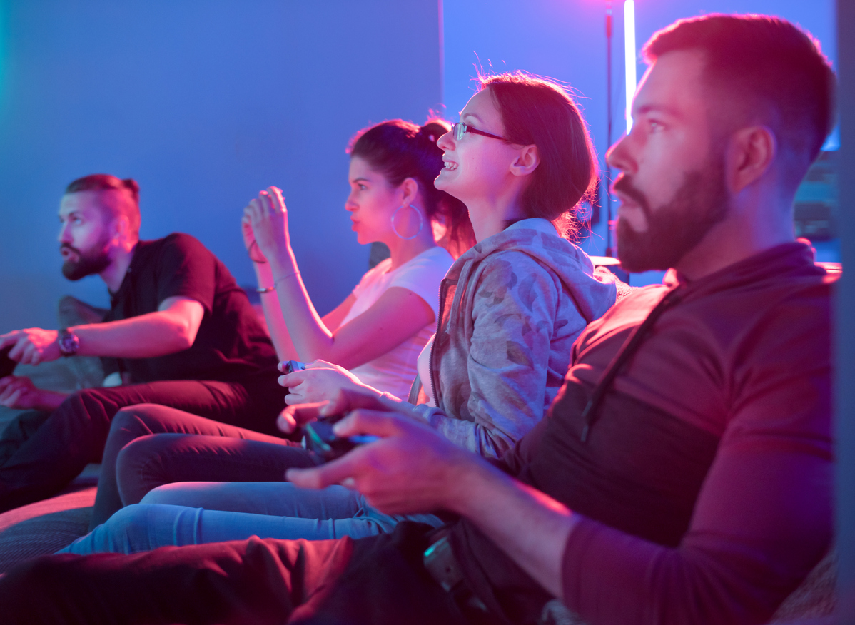 couples playing competitive video games on projector