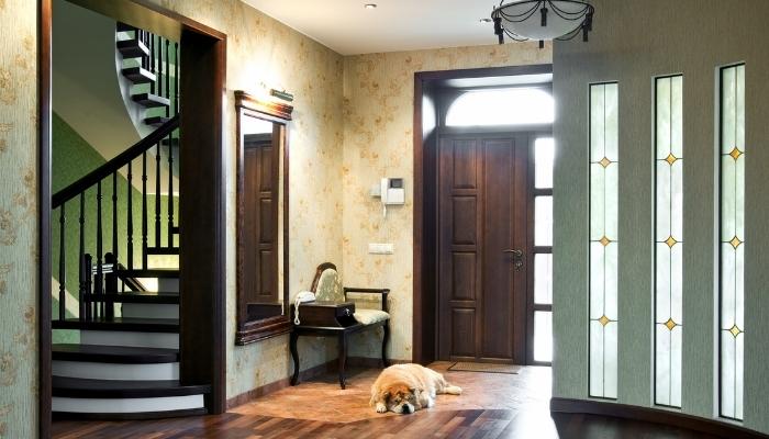Entryway with mirror, floral-accented seating and sleeping dog