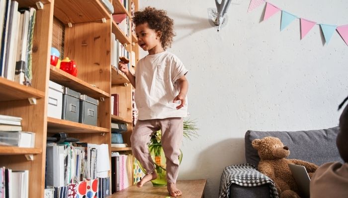 kid running to shelf that has space for toys