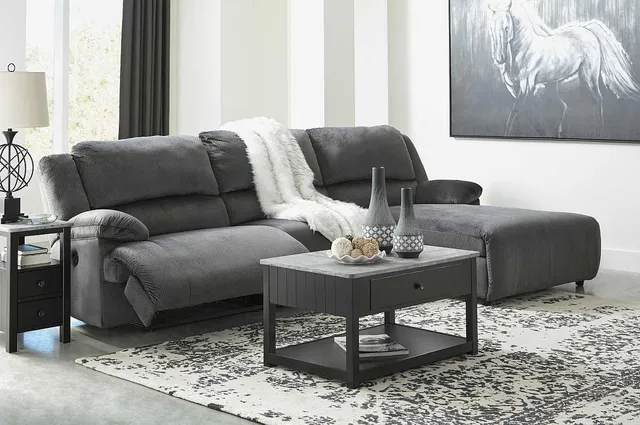 grey couch with painting and blanket