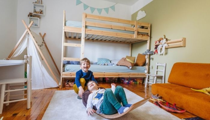 two little boys playing in bedroom