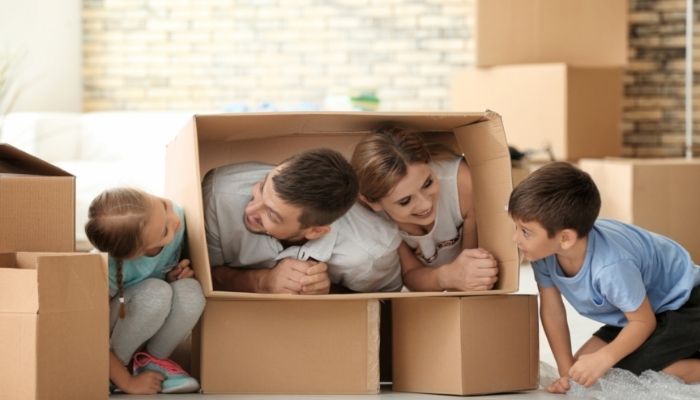 Family having fun with cardboard boxes