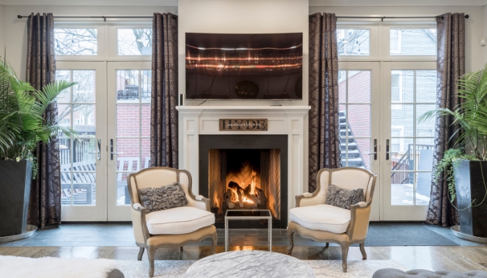 Accent chairs in front of stylish fireplace