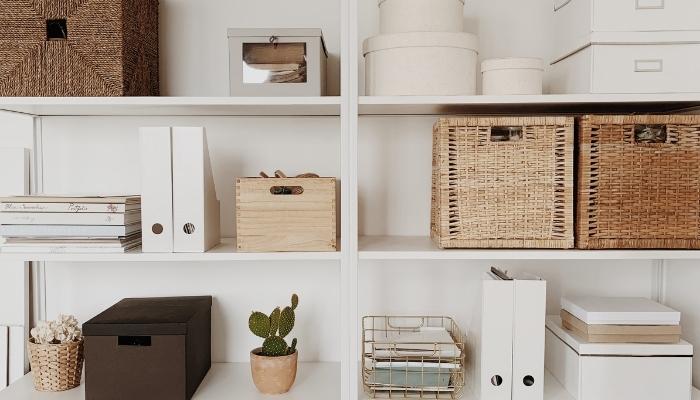 White shelves filled with baskets and bins