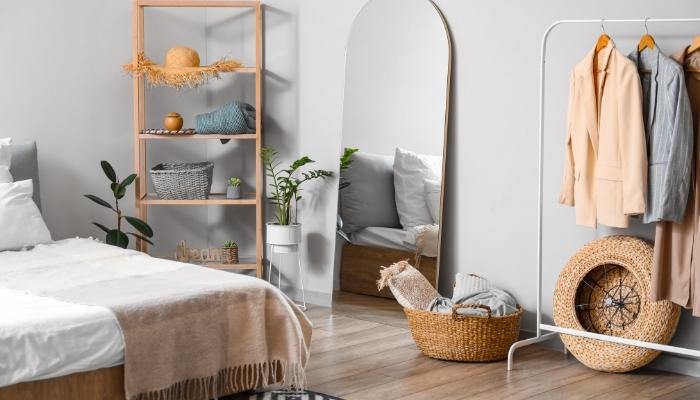 Small bedroom with a standing mirror
