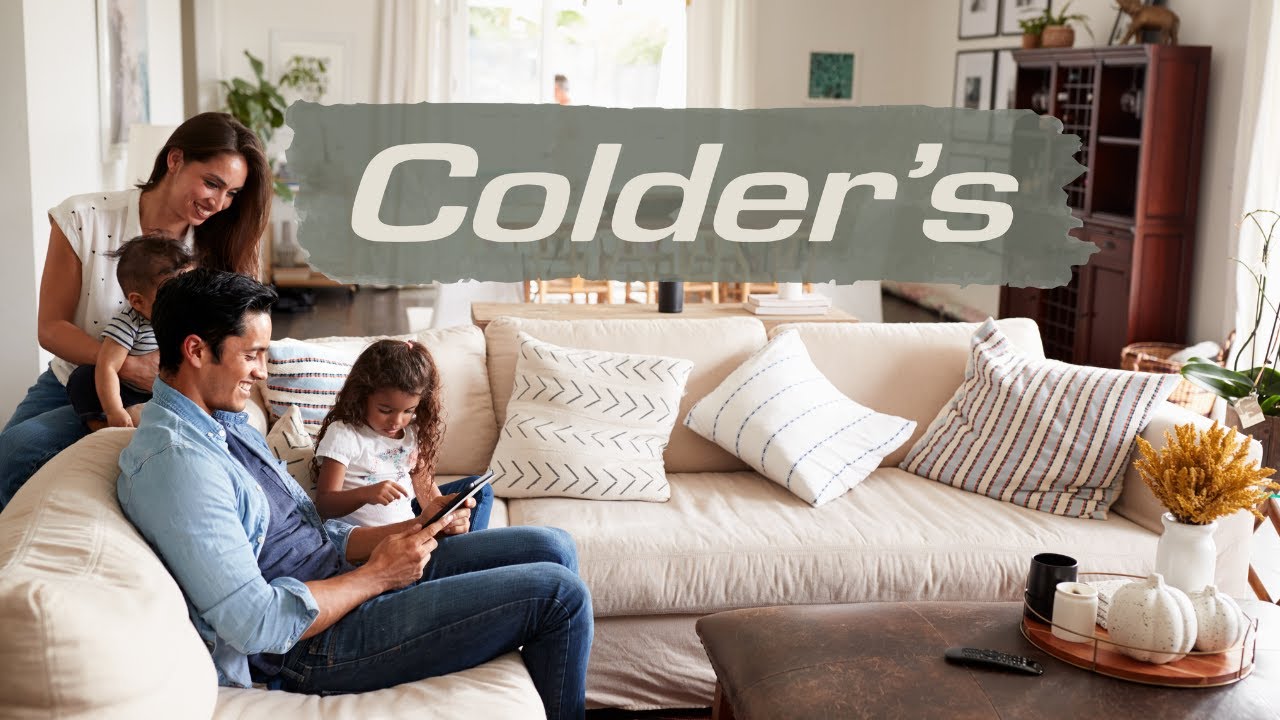 A family seated on a sectional happily explores leather sectional options on colders.com
