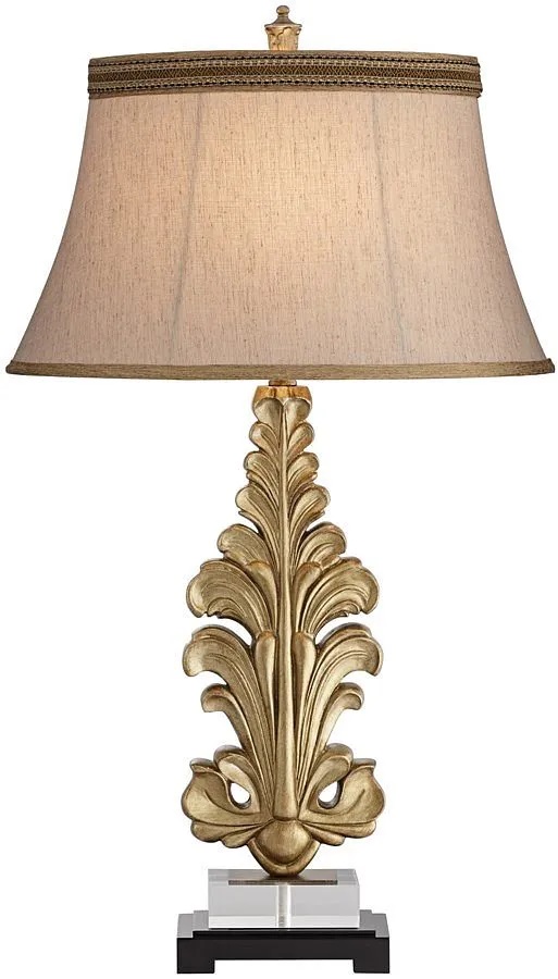 Front view of Pacific Coast golden lamp with classic fleur de lis base design 